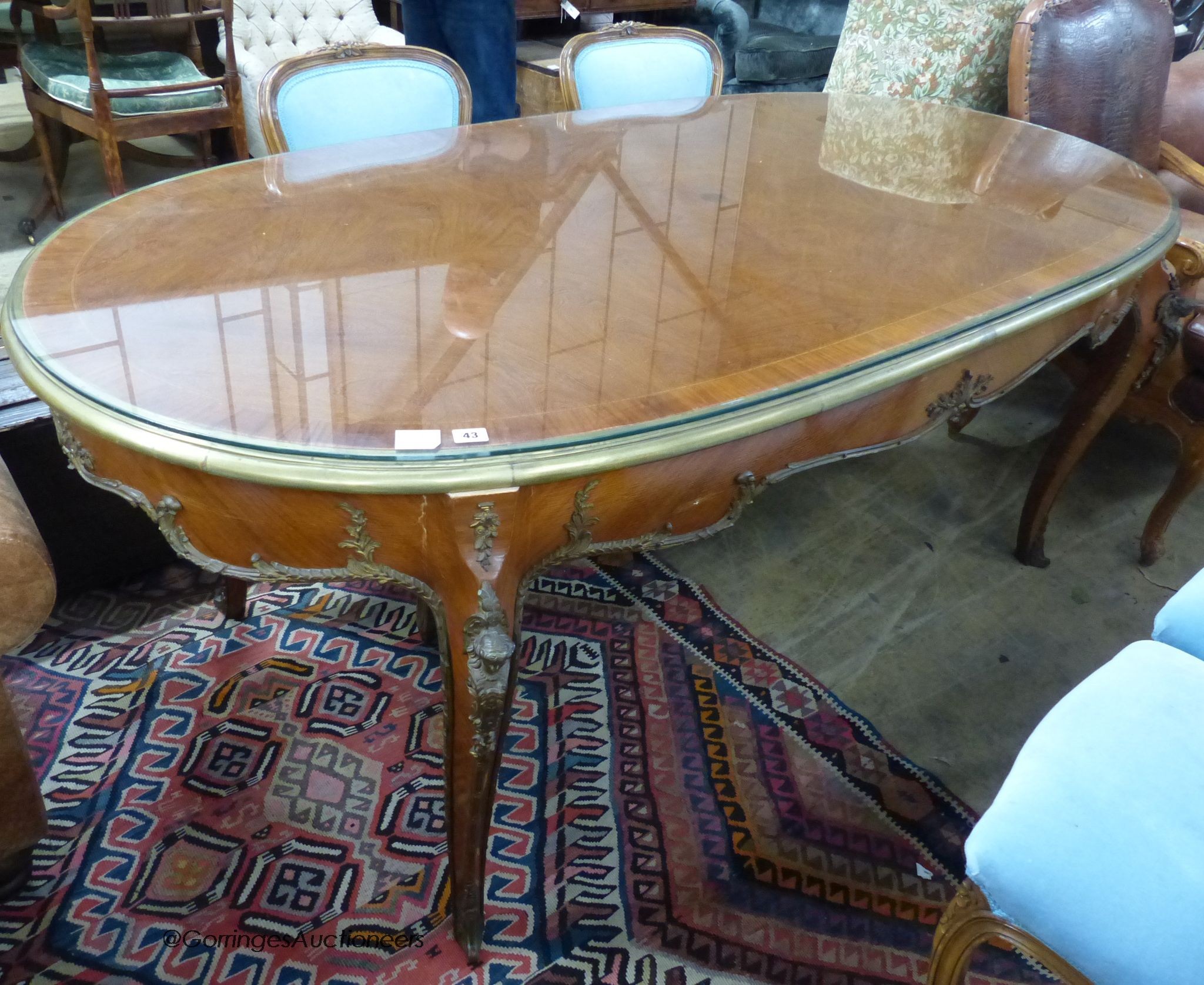 An oval gilt metal mounted Continental dining table, length 200cm, width 100cm, height 78cm